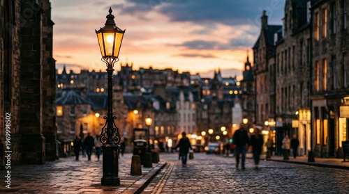 Edinburgh Old Town street lamp at dusk, cobblestone street, historic buildings, people walking