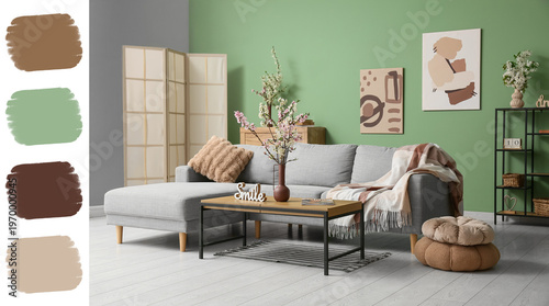 Sofa with coffee table, shelving unit and vases of blooming branches near green wall in living room