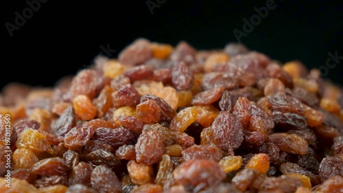 Macro texture of brown raisins, food background.