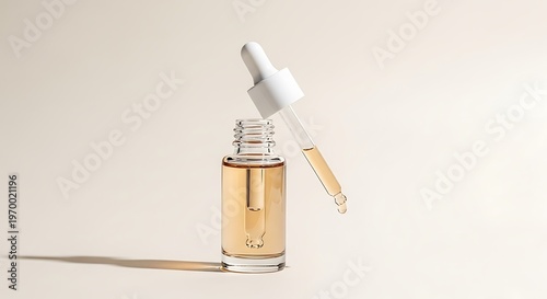 Clear glass dropper bottle with natural serum and pipette.