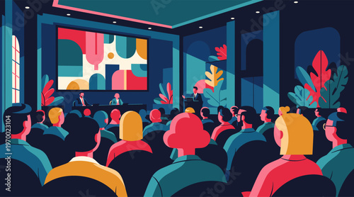 Conference audience listening to panel discussion in auditorium