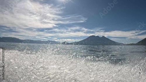 Scenic boat ride on Lake Atitlán with dramatic volcano landscape, cinematic Central America travel footage