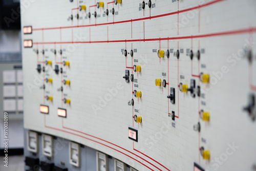 Bild auf Leinwand Close-up of an electrical control panel with grid schematic and selector switches, showing substation monitoring, power distribution, and utility operation indoors