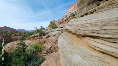 Footage capturing the experience of hiking the Canyon Overlook Trail in Zion National Park, Utah. This popular, relatively easy 1-mile round-trip trail winds along stunning sandstone cliffs and offers