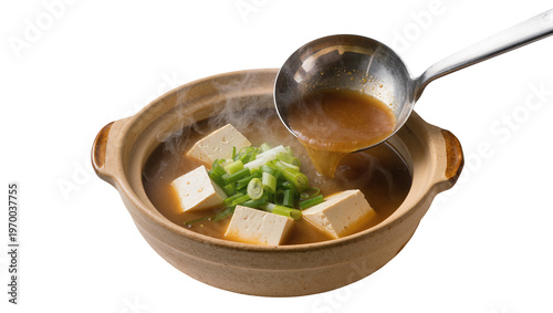 Φωτογραφία Rustic ceramic bowl holding steaming miso soup, ladled with silver spoon