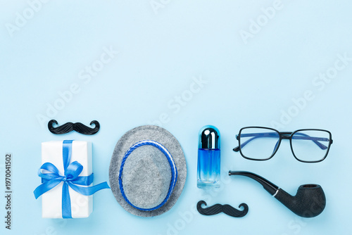 Happy Father's Day accessories on color background, top view