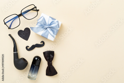 Happy Father's Day accessories on color background, top view