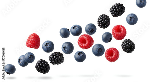 Flying mixed berries composition. Falling fresh blackberries blueberries and raspberries isolated on white background with shadow for healthy summer diets and sweet vegan dessert fruit recipes.