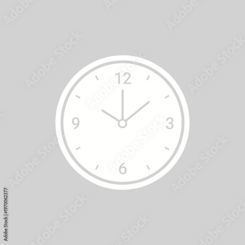 A clear, white analog clock face with black numbers and hands, set against a solid light gray background, indicating approximately 1010