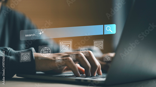 SEO search interface with user typing on laptop, Keyword research, website optimization and digital marketing analytics. Search engine strategy driving traffic, ranking and online business growth.