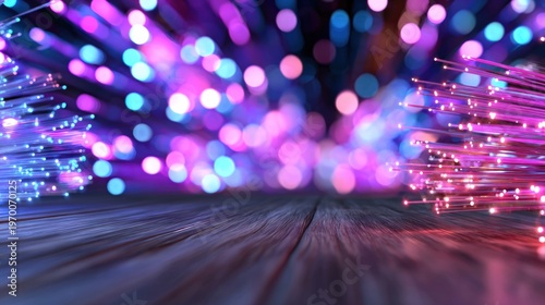 Fiber optic cables glowing blue and pink with bokeh background on dark textured surface high speed data communication technology abstract light