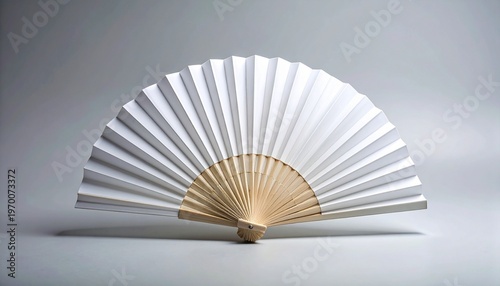 White paper hand fan with pleated folds, semicircular symmetry, radiating ribs from pivot, minimalist design on smooth gray background.