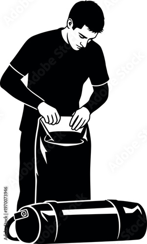 Silhouette of a man packing a duffel bag and suitcase