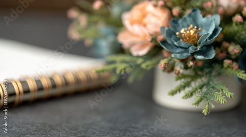 Elegant desk setup with a spiral notebook and decorative floral arrangement serene workspace decor and organization with a touch of nature