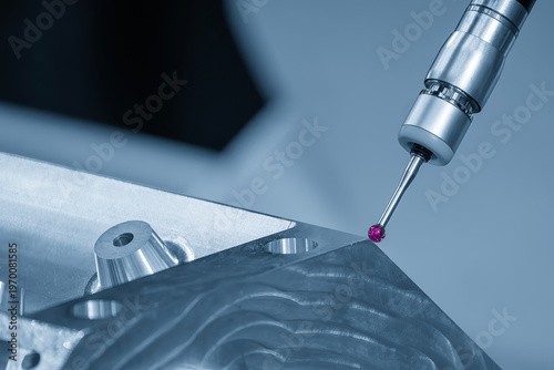 Advanced multi-axis CMM machine measuring a high-precision aluminum engine block for automotive quality inspection.