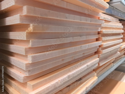 Фотография Stacks of smooth wooden planks waiting for creative craftsmanship