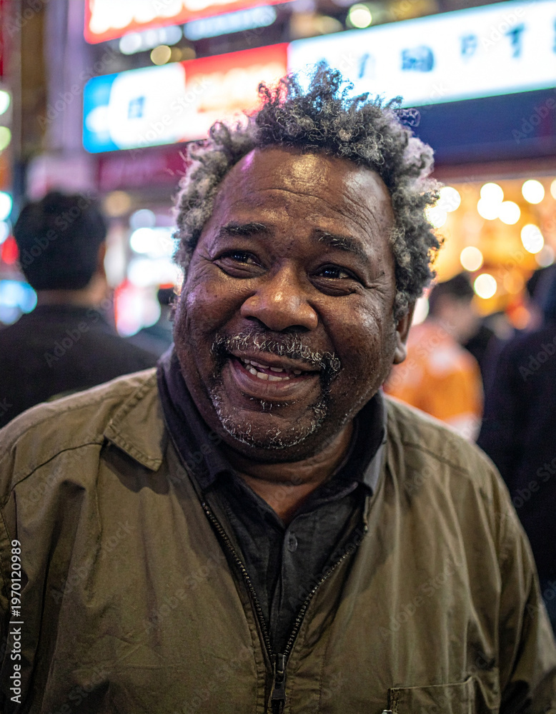 Obraz premium Smiling Senior Black Man on Tokyo Street at Night, Authentic Aging