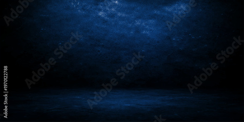 A dark blue sky with clouds reveals a moody texture of night and storm light as fog rolls over the deep blue sea backdrop