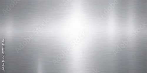 Polished silver brushed metal texture background featuring a shiny stainless steel plate surface with industrial gray aluminum reflections and a light metallic pattern backdrop