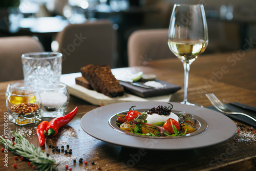 Indulge in Gourmet Burrata paired exquisitely with colorful Heirloom Tomatoes and a touch of Caviar
