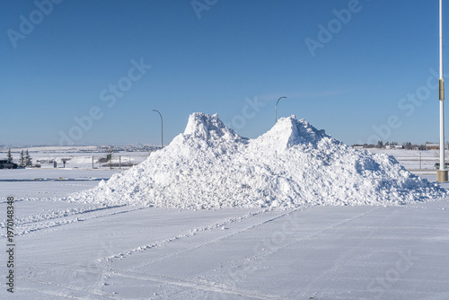Pile of snow cleared after a snowstorm in parking lot