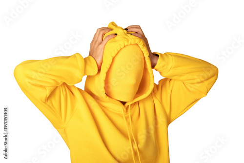 Anonymous person in a bright yellow hoodie with covered face, hands on head, isolated on transparent background, concept of identity or anonymity.