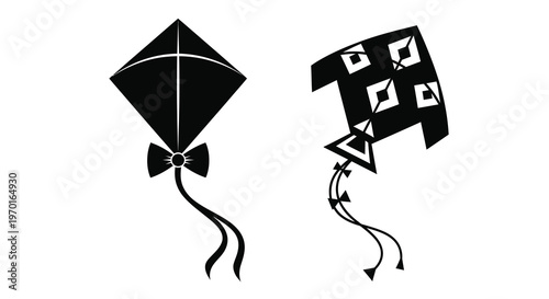 Two black kites with distinctive designs shown in dark silhouette