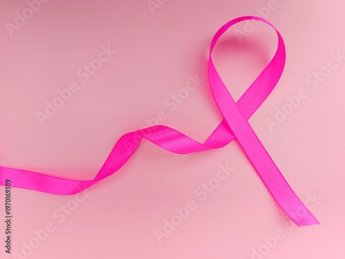 breast cancer ribbon. Pink ribbon, breast cancer awareness symbol, isolated on pink coloured background 