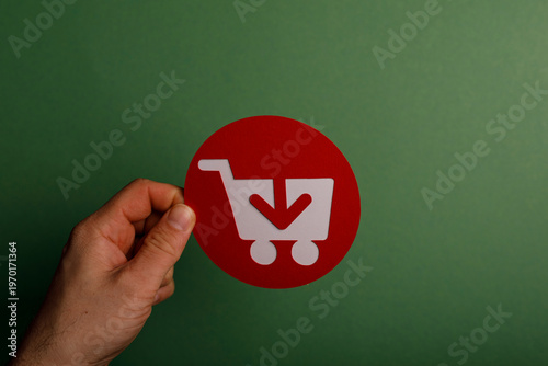 Person's hand holding a red...
