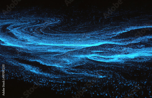 Electric blue bioluminescent plankton illuminate crashing waves in a dark night sea. The glowing light creates sparkling, swirling patterns, capturing a rare and magical natural phenomenon