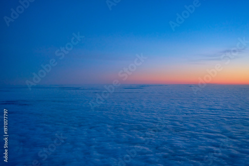 A magnificent sunset sky above a solid layer of clouds, high altitude photograph