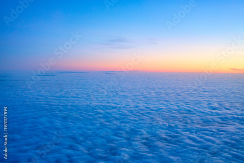 Breathtaking aerial view of a vibrant sunrise over a vast sea of clouds from an airplane window Travel transportation solution.