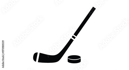 A stark black silhouette depicts a hockey stick and puck resting on a white background creating a simple image silhouette