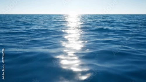 A serene shot of the vast ocean under a clear, bright sky. Sunlight sparkles on the surface