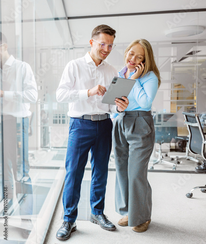 Business colleagues managers people discussing ideas together in a modern office space during a sunny afternoon