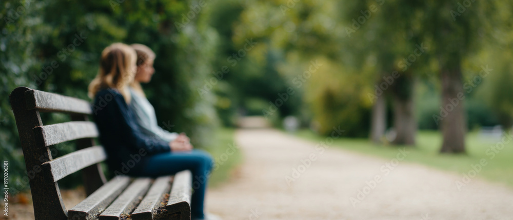 © perfectlab - Two people sitting on park bench outdoors © perfectlab - Two people sitting on park bench outdoors