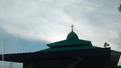 Close-up of Green Mosque Roof with Small Dome and Finial.