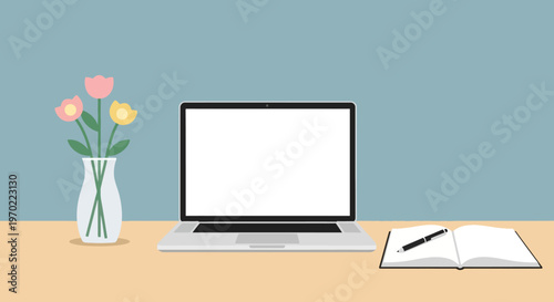 Laptop on a desk with flowers.