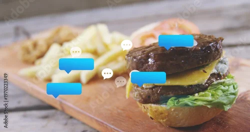 Fototapeta Showing double-cheeseburger on wood board at rustic table with fries and speech-bubbles, copy space