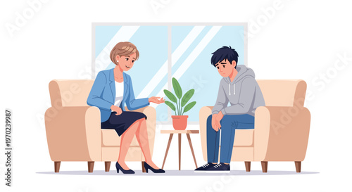 A female therapist in a blue blazer talks to a sad young man in a grey hoodie in an office setting.