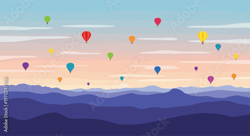 Numerous colorful hot air balloons float across a serene sky with soft clouds above a range of purple and blue mountains.