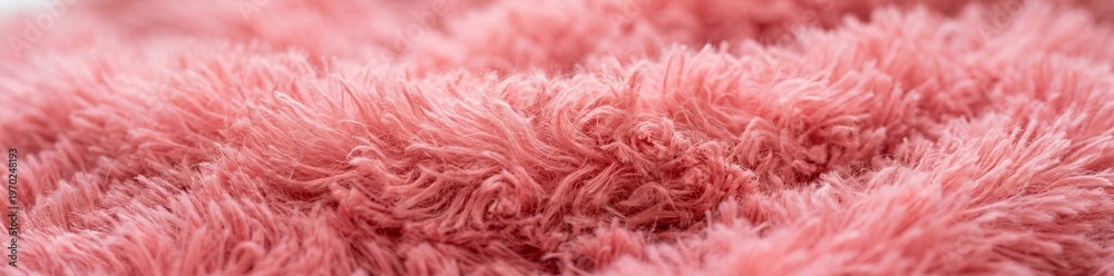 Obraz premium A close-up photograph displays the gentle, fluffy texture of a vibrant pink textile. The image emphasizes the soft, cloud-like quality of the material.