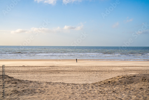 Photography Infinite beach and dunes in Koksijde with a lonely figure, Belgium