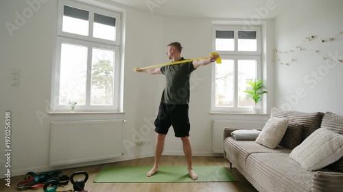 Man Exercising With Resistance Band At Home