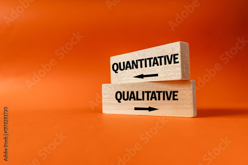 Quantitative or qualitative choice.  Quantity vs quality. Business concept. Red and green arrows pointing in opposite directions on white blocks. orange background, copy space.