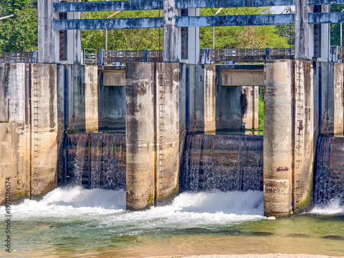 Image of a concrete dam with water cascading through it. This structure is a marvel of engineering, built to control and manage water flow.