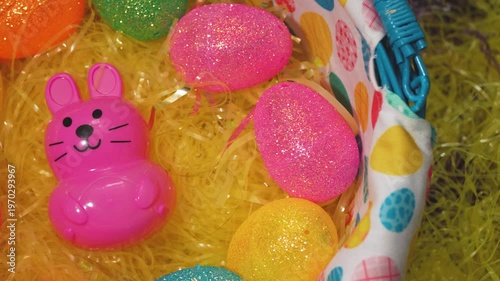 Slow Panning Shot Of A Pink Plastic Easter Bunny In A Basket