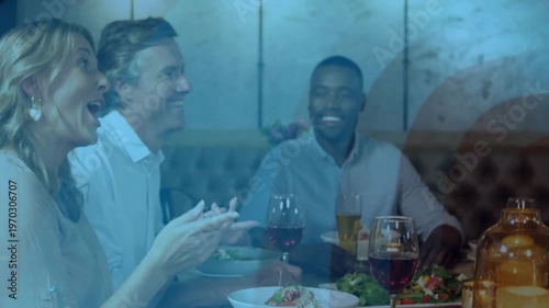 Camera pulling back restaurant diners celebrating with wine and clapping, blue overlay tinting