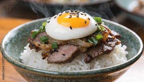 A steaming bowl of rice topped with thinly sliced beef, onions, and a perfectly poached egg, garnished with sesame seeds and green onions 2