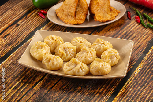 Plate of traditional steamed dumplings Momo on a table. Asian cuisine concept.